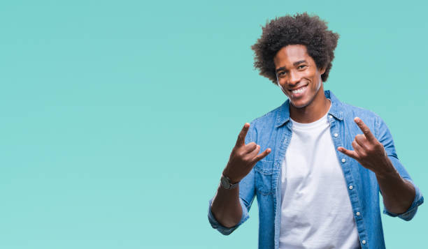 istock Afro american man over isolated background shouting with crazy expression doing rock symbol with hands up. Music star. Heavy concept. 1124763929