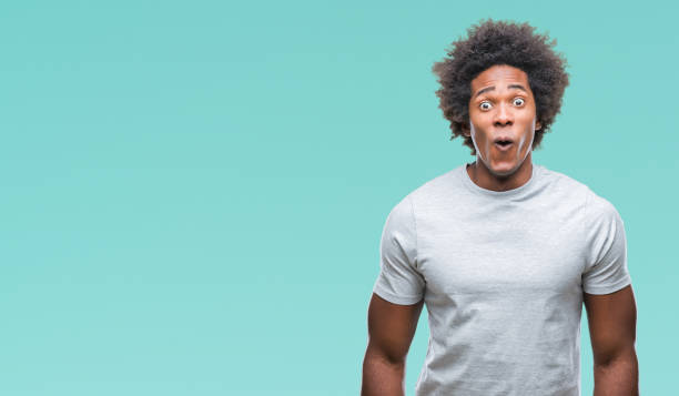 istock Afro american man over isolated background afraid and shocked with surprise expression, fear and excited face. 1124764037