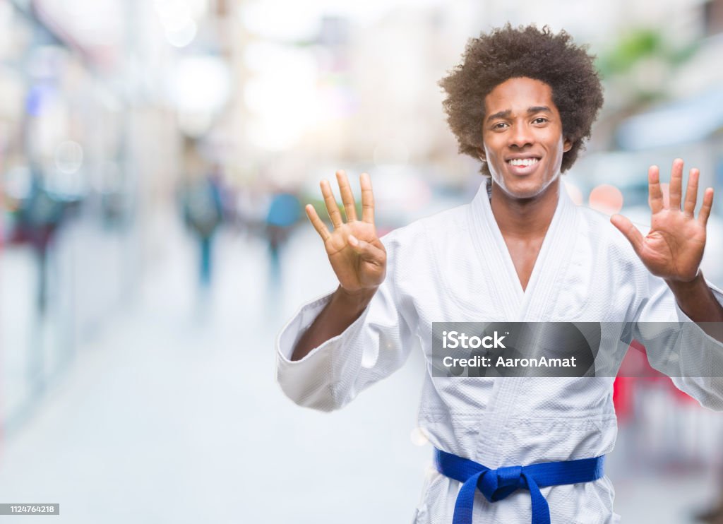 Afro American Man Wearing Karate Kimono Over Isolated Background Showing And Pointing Up With Fingers Number Nine While Smiling Confident And Happy Photo - Download Image Now - iStock