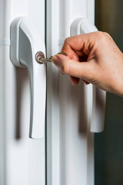 istock woman locking up a safety window 1124764447