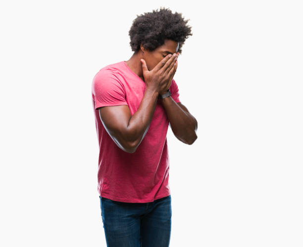 istock Afro american man over isolated background with sad expression covering face with hands while crying. Depression concept. 1124764524