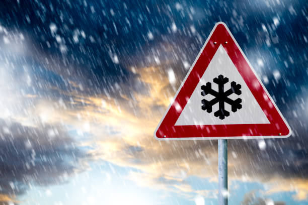 istock winter driving - warning sign - risk of snow and ice 1124764585