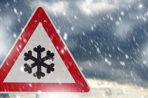 istock winter driving - warning sign - risk of snow and ice 1124764761