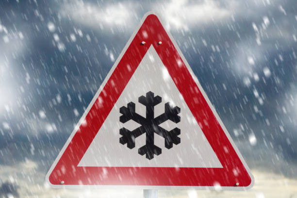 istock winter driving - warning sign - risk of snow and ice 1124764862