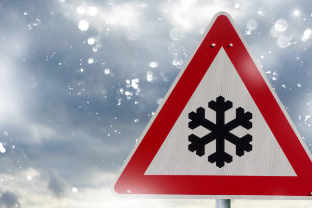 istock winter driving - warning sign - risk of snow and ice 1124764865