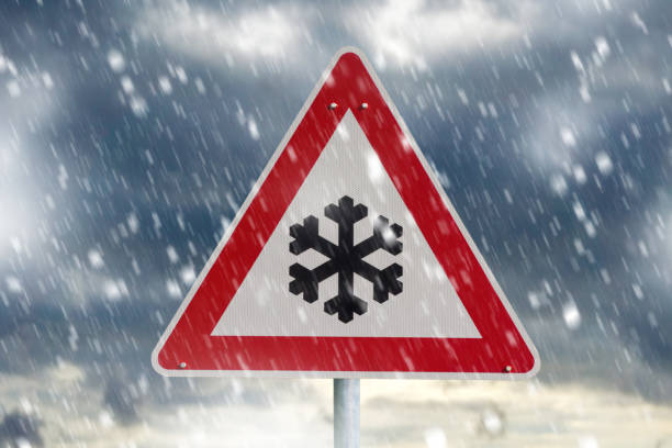 istock winter driving - warning sign - risk of snow and ice 1124764893