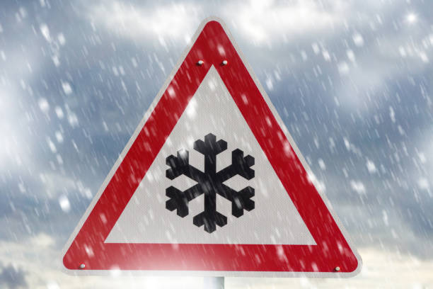 istock winter driving - warning sign - risk of snow and ice 1124765003