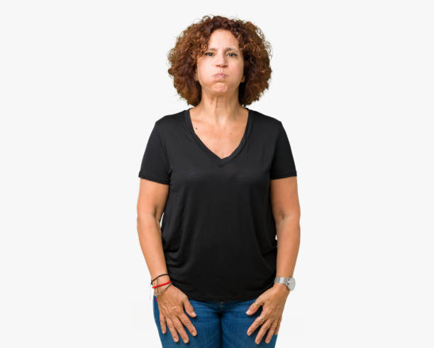 istock Beautiful middle ager senior woman over isolated background puffing cheeks with funny face. Mouth inflated with air, crazy expression. 1124765607