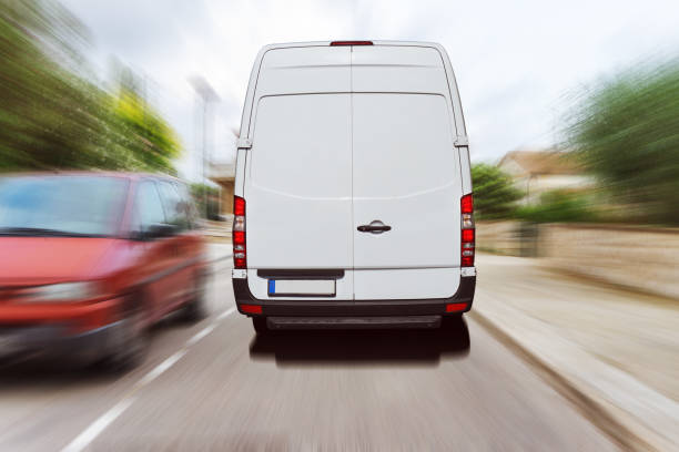 istock Delivery van drives through a city 1124765670