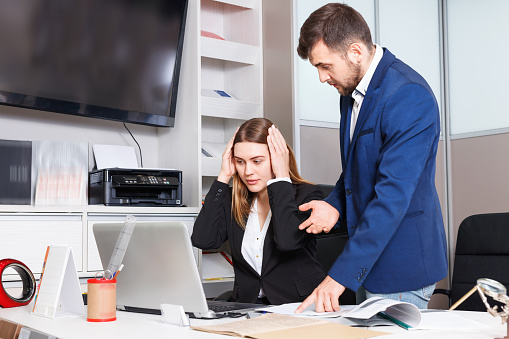 Dissatisfied  unhappy manager scolding frustrated salesgirl at workplace in furniture salon