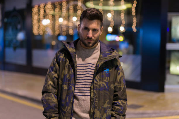 istock Young handsome man possing and smiling. Street style at night 1124771353