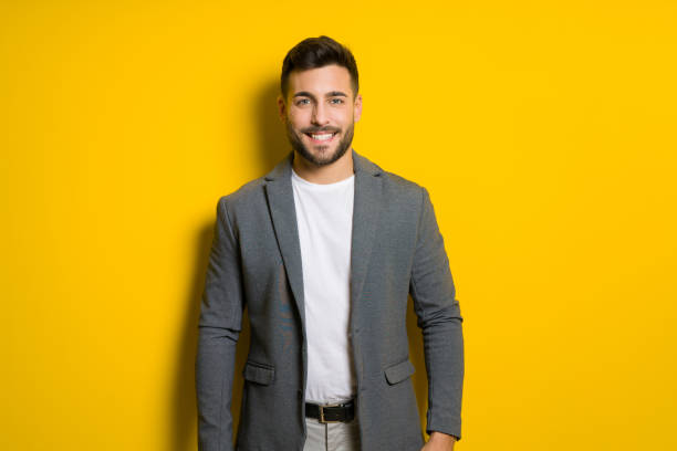 istock Young handsome man possing and modeling over yellow isolated background 1124771467