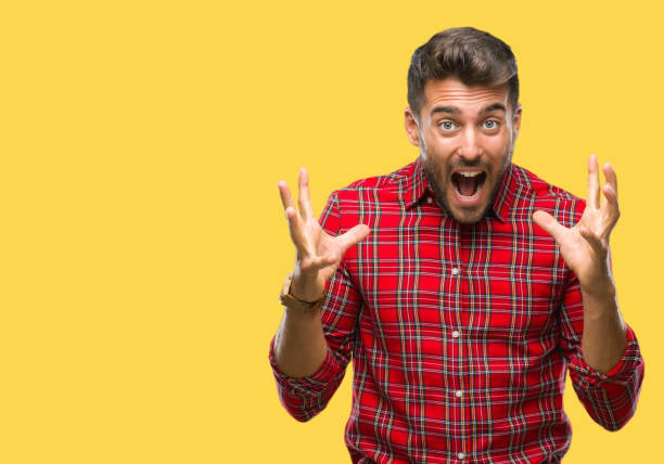istock Young handsome man over isolated background celebrating crazy and amazed for success with arms raised and open eyes screaming excited. Winner concept 1124772690