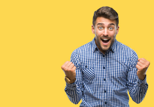 istock Young handsome man over isolated background celebrating surprised and amazed for success with arms raised and open eyes. Winner concept. 1124772776