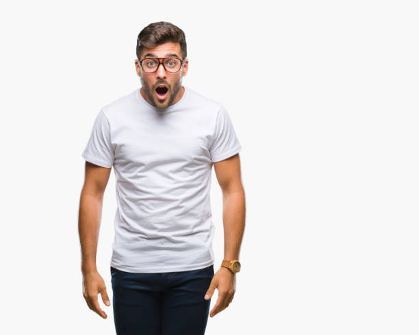 istock Young handsome man wearing glasses over isolated background afraid and shocked with surprise expression, fear and excited face. 1124773893