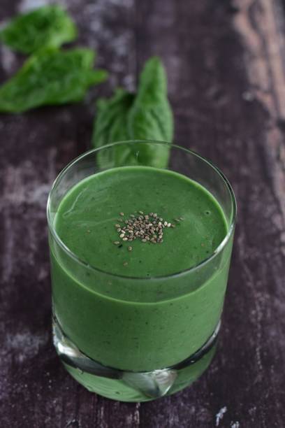 istock Spinach spirulina green smoothie on wooden background 1124776376