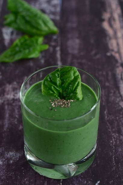 istock Spinach spirulina green smoothie on wooden background 1124776526