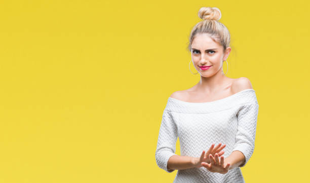 istock Young beautiful blonde and blue eyes woman over isolated background disgusted expression, displeased and fearful doing disgust face because aversion reaction. With hands raised. Annoying concept. 1124779433