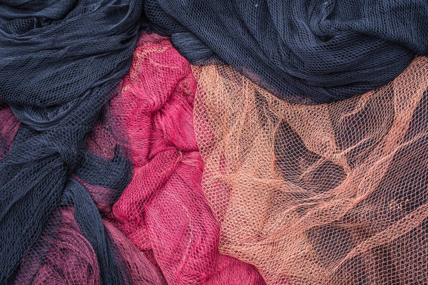 Detail of black and red fishing nets with white floats. traditional works stock photo