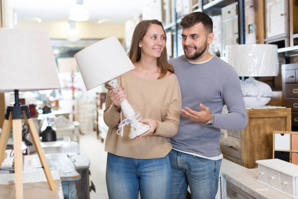 istock Couple looking for stylish table lamp 1124781749