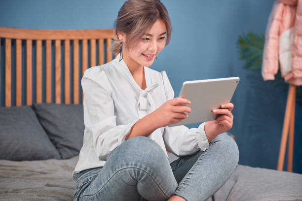 istock girl reading from tablet in the bed 1124782593