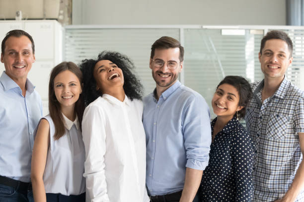 istock Happy team standing together in row looking at camera 1124783366