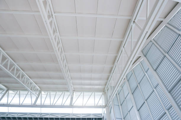 istock Large steel structure truss, roof frame and metal sheet in building construction 1124785755