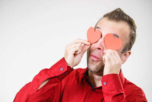 istock Man in love with hearts on eyes 1124786132