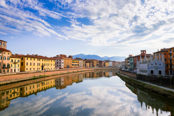 View of the river Arno lined with Santa Maria della Spina church and colorful buildings in the city of Pisa, Pisa, Tuscany, Italy, Europe stock photo
