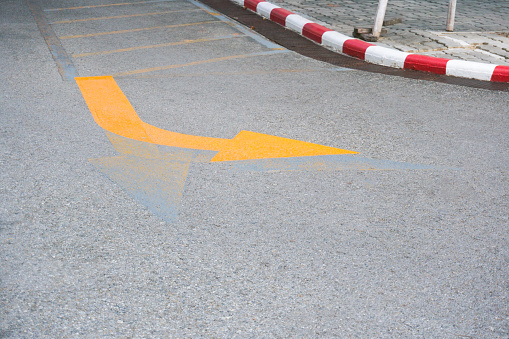 Traffic Signs ,yellow arrow Turning right road sign on the road floor