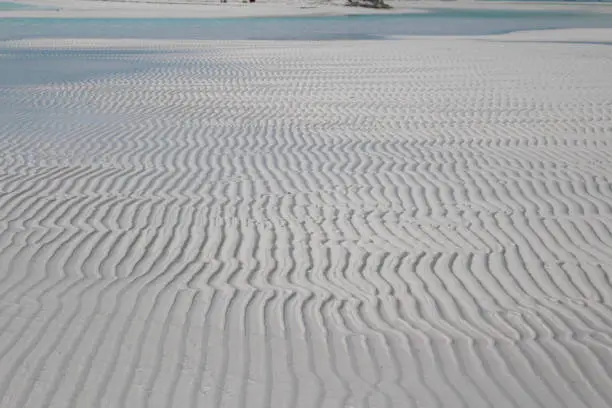The alternation of waves and tides causes unique designs in the sand of Sandi Cay, Bahamas