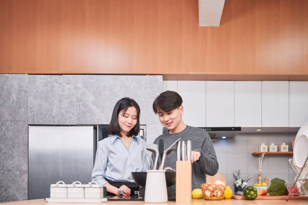 istock Young Chinese Couple in Kitchen 1124787940