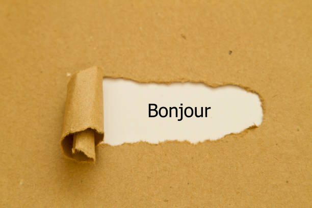 istock French Bonjour (hello) word written under torn paper. 1124789950