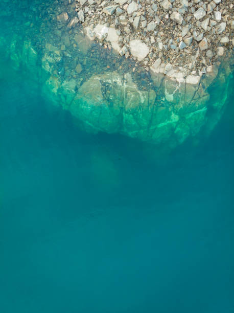 istock Blue water and rocks, view from above 1124790299