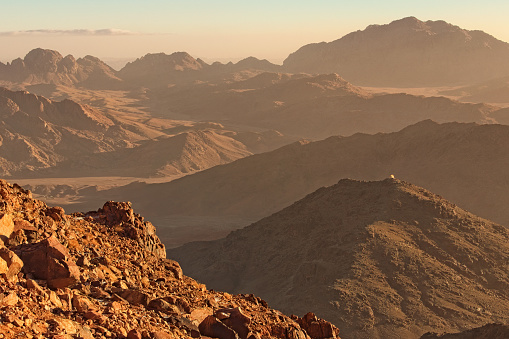 Picturesque landscape of mountains peaks during sunrise. View from Mount Sinai (Mount Horeb, Gabal Musa). Sinai Peninsula of Egypt. Famous touristic place and travel destination in Egypt.