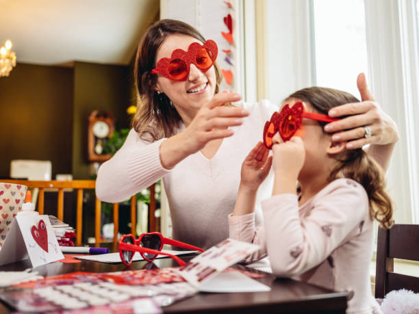 istock Mother and young daughter crafting for Valentine's Day 1124800132