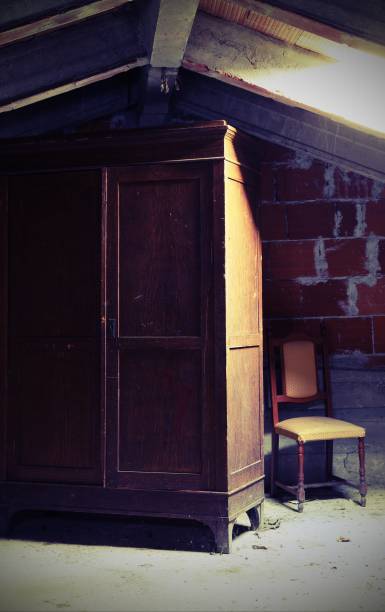 istock gloomy attic with an old wooden wardrobe with old effect 1124800317