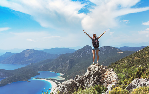 Hiker girl on the mountain top, oncept of freedom, victory, active lifestyle, Oludeniz, Turkey