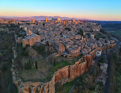 Aerial shot of a hilltop town after sunset