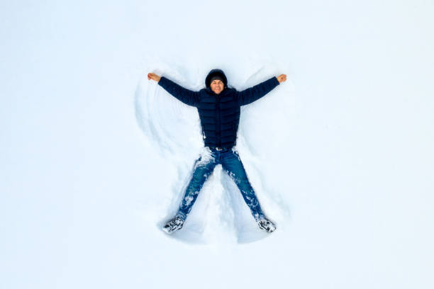 istock The boy on a snow flapping arms and legs angel shows. 1124804943