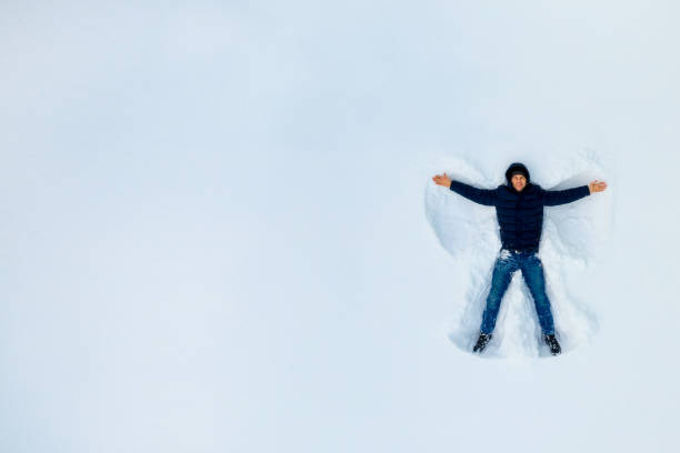 istock The Boy on a snow angel shows. Copy space. 1124804949