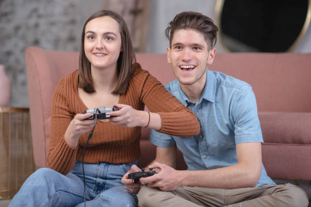 istock Millennial couple cheerfully gaming together 1124806498