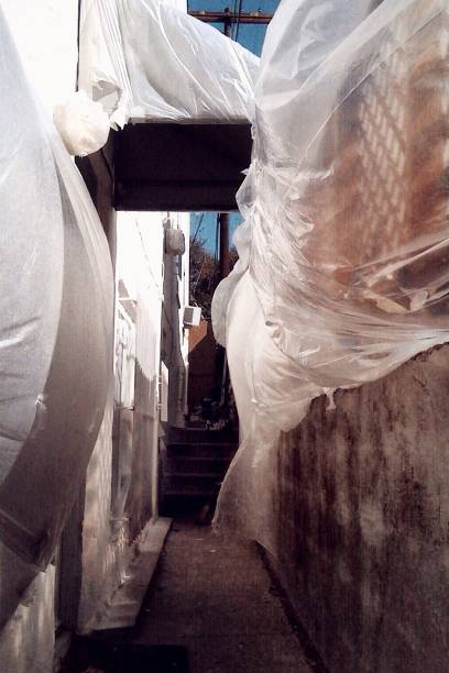 istock Plastic covering blows in the wind in a narrow alley 1124806877