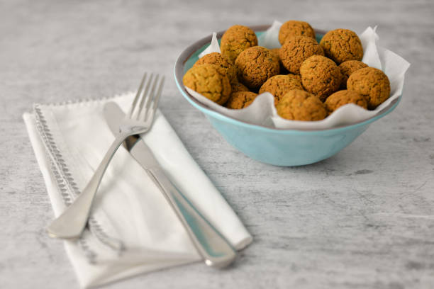 Baked chickpea falafel balls on blue plate on grey background , healthy and vegan food with tahini deep and hot pepper , traditional Mediterranean , top view , flat lay with copy space stock photo