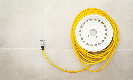 Yellow garden hose rolled up