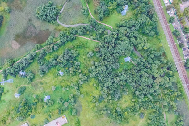 Idyllic aerial view of a country house with a yard, ancillary buildings and an orchard