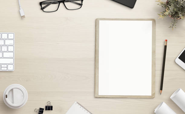 istock Blank paper on office desk with copy space beside. Office accessories beside. 1124815217