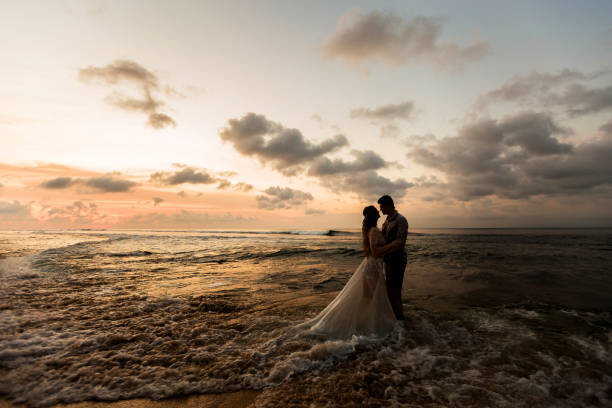 istock Young couple on the beach at sunset 1124826644