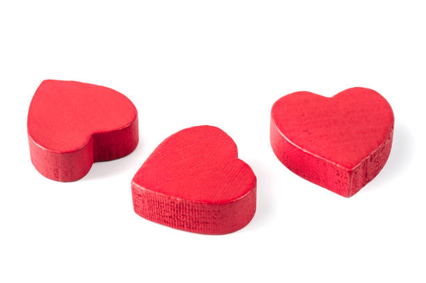 istock Three red wooden hearts isolated on white 1124836960