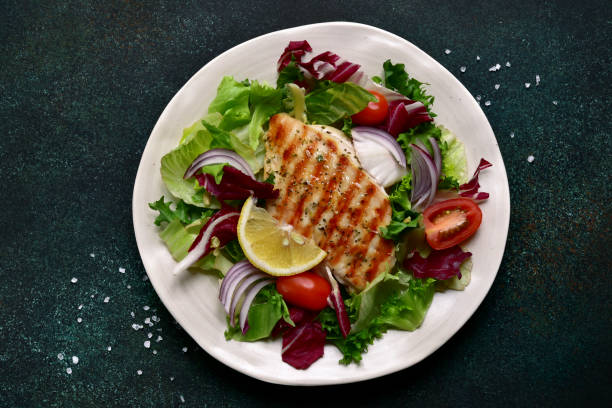 istock Grilled chicken or turkey breast with fresh vegetable salad 1124837778